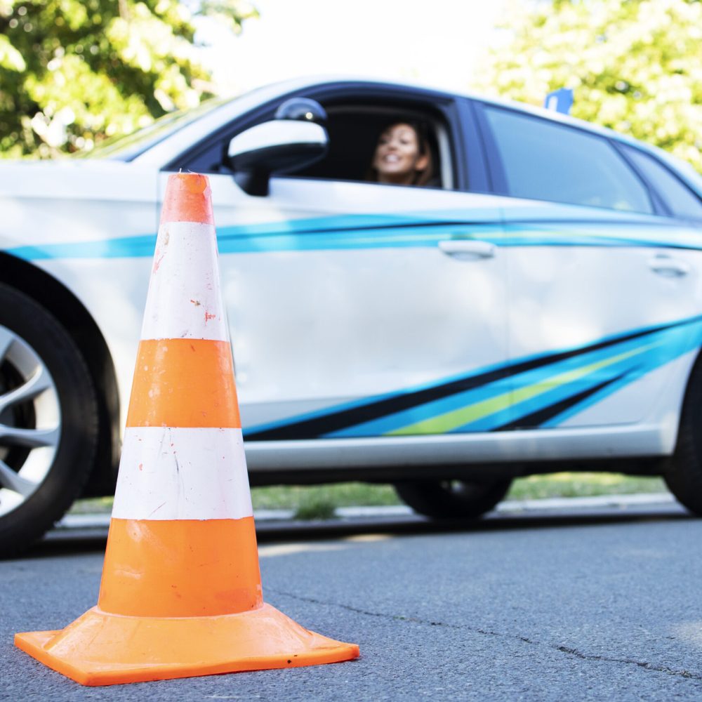 Young beautiful woman sitting in school car ready for classes.